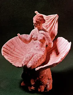 Aphrodite: Aphrodite kneeling in a Shell - terracotta statuette