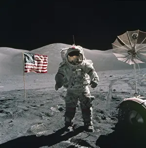 Spacesuits: Apollo 17 Astronaut stands between a US ?