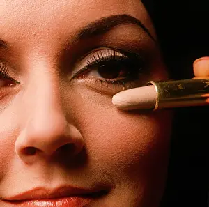 Mascara: Applying concealer makeup on female model