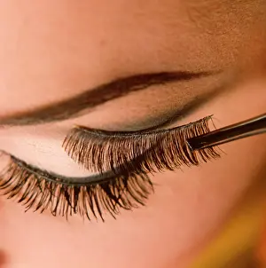 Mascara: Applying false eyelashes to female model