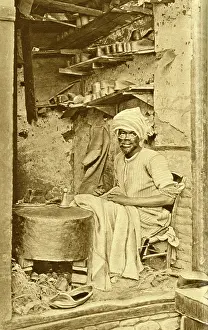 Shopkeeper: Arab cobbler at work in his shop, Cairo, Egypt