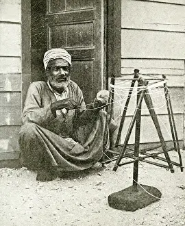 Twine: Arab fisherman winding twine for nets, Port Said, Egypt
