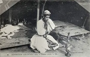 Outremer: Arab smoking hookah, 1907 Colonial Exhibition