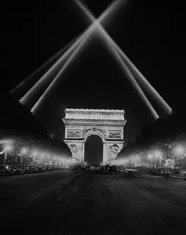 Elysees: Arc de Triomphe in Paris at night, 1938