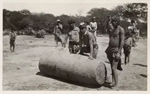 Tribesmen: Argentina - Indigenous Tribesmen roll a bottle tree trunk