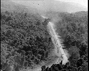 Ariel: Ariel View of Supply Trucks Driving Down a