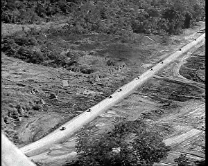 Ariel: Ariel View of Supply Trucks Driving Down a