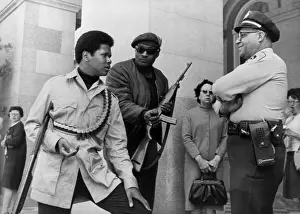 Panthers: Two armed Black Panthers, carrying a shotgun, ?