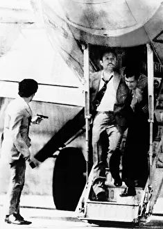 Hijacker: An armed hijacker (left) watches as Turkish ?