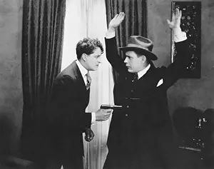 Corrupt: Armed man holding up man in hat