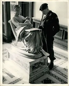 Symbolise: Army cadet reads notes resting on sculpture, Eaton Hall