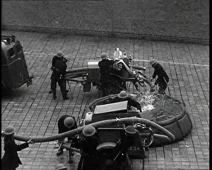 Hoses: ARP Wardens in Helmets Filling Small Fire Engines