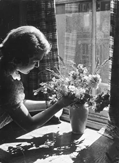 Arranges: ARRANGING FLOWERS