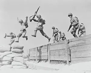 Barrier: Artillerymen take a running leap over an obstacle