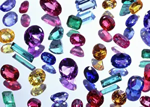 Gemstones: ASSORTED GEMSTONES ON REFLECTIVE SURFACE