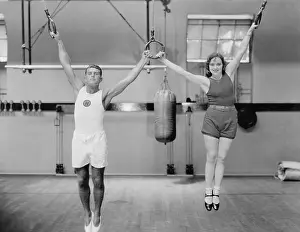 Gymnasiums: Athletes on rings in gym