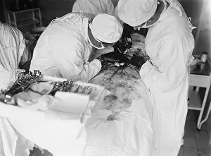 Sedation: Attending surgeon leans over to work closely over