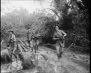 Trudging: Australian Troops Trudging Through Mud in New Guinea