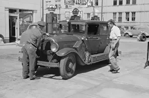 Migrant: Auto of migrant fruit worker at gas station, Sturgeon Bay, W