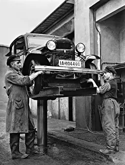Jacked: Automobile on a lifting platform, 1937
