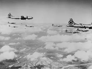 In Flight: B-29s formation is shown dropping bombs over enemy