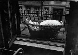 Windowsill: Baby in basket on windowsill
