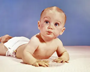 Outrageous: Baby Boy Lying on his Stomach Making Funny Face