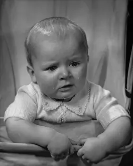 Glancing: Baby boy with tears running down his face