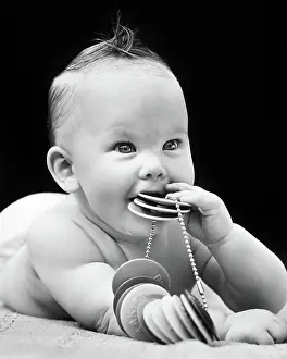 Diapers: Baby Chewing on Plastic Teething Toy