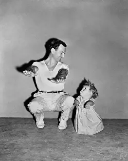Imitating: Baby girl imitating dad