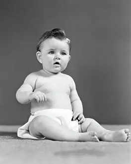 Diaper: Baby Girl looking at Camera Quizzically