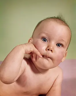 Quizzical: Baby Looking at Camera Pursed Lips Hand up to
