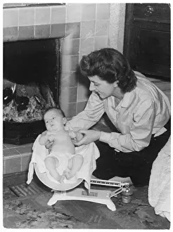 Nappy: BABY BEING WEIGHED