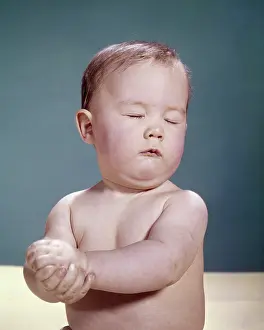 Wringing: Baby Wringing his Hands Eyes Closed in Worry Or