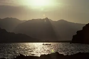 Ripples: Backlit boat beneath the Taurus mountains, Antalya, Turkey