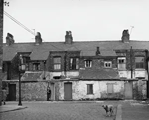 Cobblestones: Backs of houses viewed from an alleyway