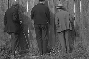 Shahn: The backs of three men watching a football ?