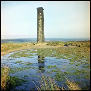 Intensively: Bank Top Chimney viewed across a small reservoir The