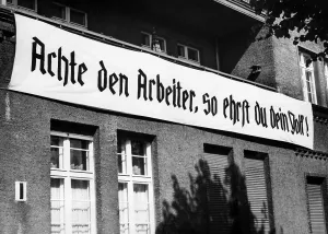 Saying: A banner saying Respect the worker, and honour