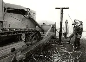 Bulldozer: Barbed wire fence - border - frontier - dismantling