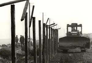 Bulldozer: Barbed wire fence - border - frontier - dismantling