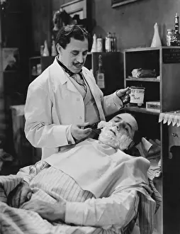 Reclined: Barber shaving mans face