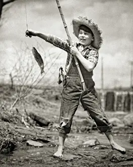 Slingshot: Barefoot Boy in Overalls in Stream