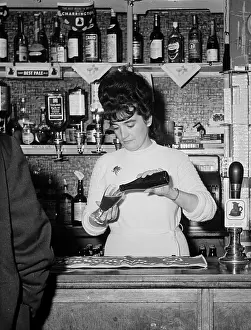Pours: BARMAID POURING DRINK