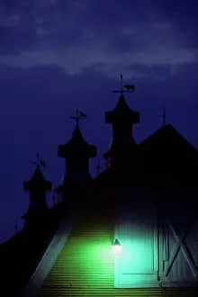 Gloom: BARN AT TWILIGHT WITH NIGHT LAMP ON SIDE OF BUIDLING