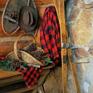 Snowshoes: BASKET OF PINE CONES NEXT TO RED CHECKERED SHIRT