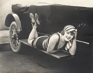 Ov1606: Bathing beauty posing on running board of convertible