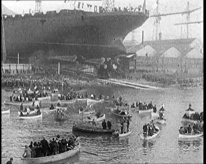 Slides: A Battleship Slides Down into the Water. Alongside