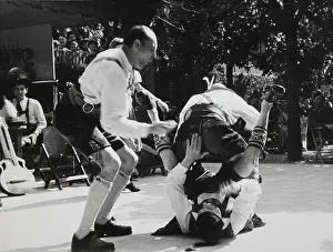 Contortions: Bavarian Schuhplattler group in strange