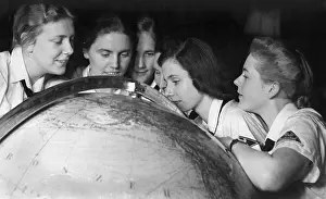 Lebens: BDM girls looking at a globe, 1940